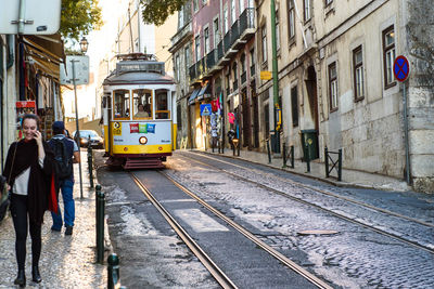 People on railroad tracks in city