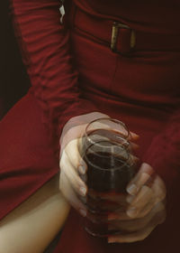 Close-up of hand holding glass bottle