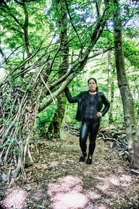 Portrait of young woman standing in forest