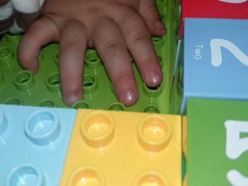 Close-up of hand holding plastic toy