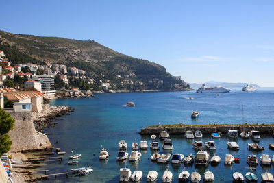 Busy harbor with cruise ships in distance coming into dubrovnik