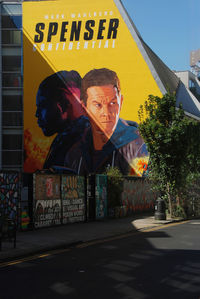 Man with graffiti on street in city