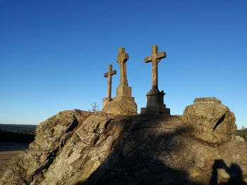 Cross against clear blue sky