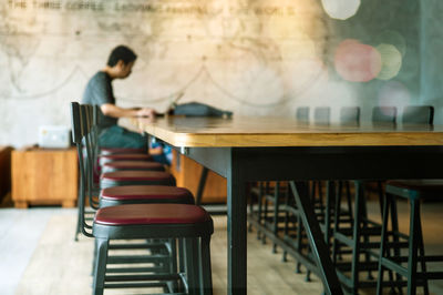 Man sitting on bench in table