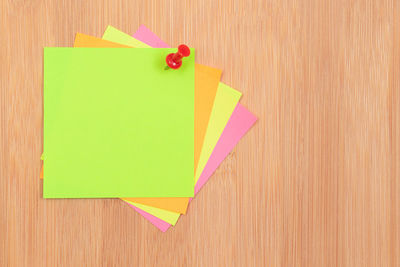 Close-up of multi colored paper on wooden table