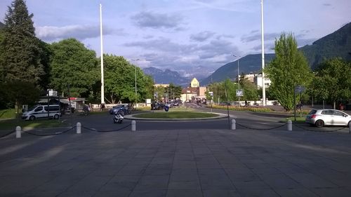 Cars on road in city against sky