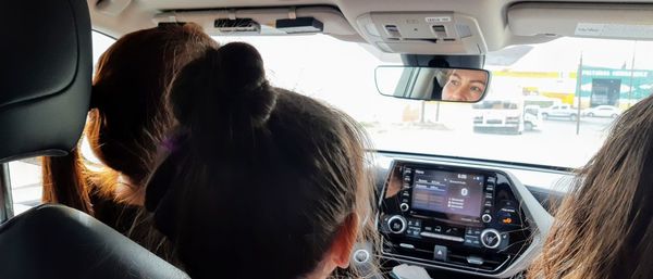 Rear view of woman sitting in car