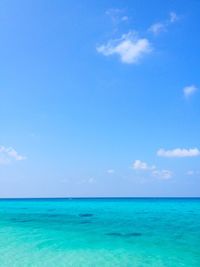 Scenic view of sea against blue sky