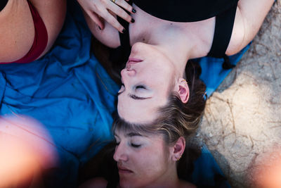 High angle view of woman lying on friends