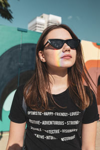 Young woman with long hair wearing sunglasses