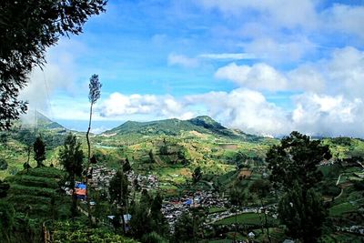 Scenic view of mountains against cloudy sky