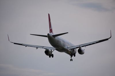 Low angle view of airplane flying in sky