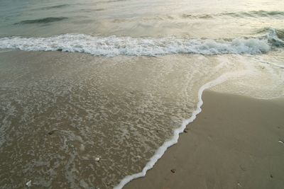 High angle view of waves rushing towards shore