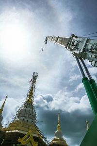 Low angle view of cross against sky