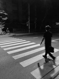 Side view of man walking on road