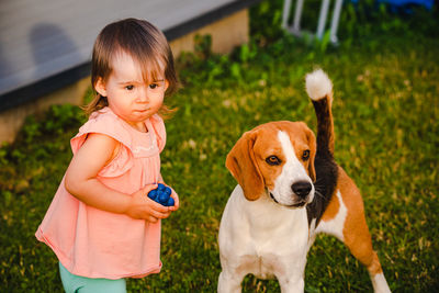 Cute girl and dog at back yard
