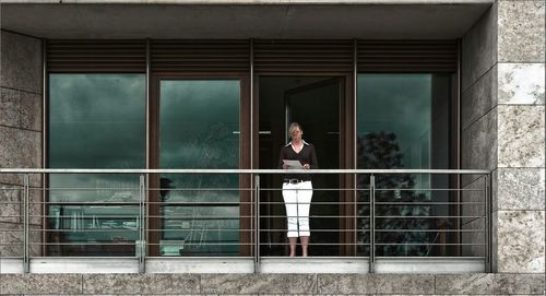 Man seen through window of building