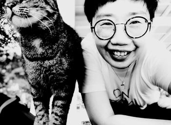 Portrait of smiling young woman with cat