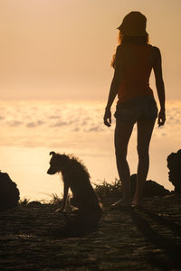 Man with dog at sunset