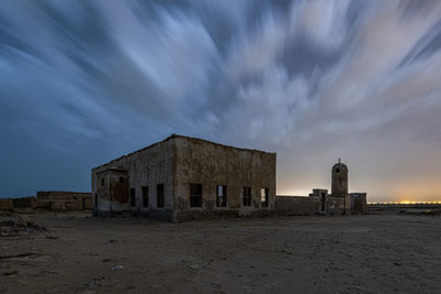 Abandoned building against sky at dusk