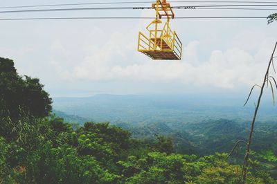 Low angle view of ski lift against sky