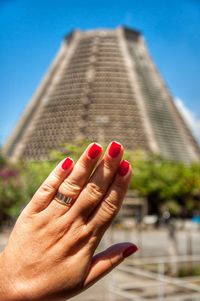 Close-up of woman hand on red building