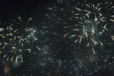 Low angle view of firework display at night