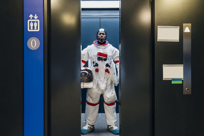 Portrait of man standing by door