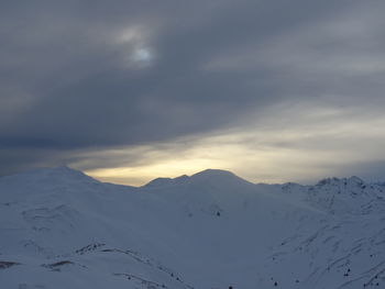 Scenic view of snow covered mountains against sky