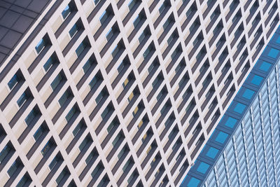 Low angle view of modern glass building in city