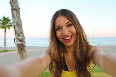 Portrait of smiling young woman at beach