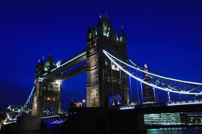 Low angle view of suspension bridge at night