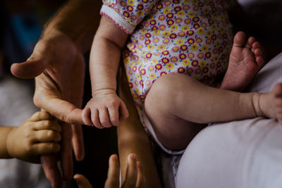 Midsection of baby sitting with father at home