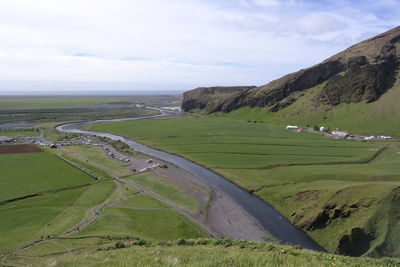 Scenic view of agricultural landscape against sky