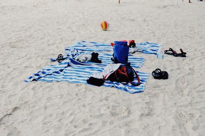 Backpacks on towels at beach