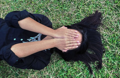 Woman lying on field