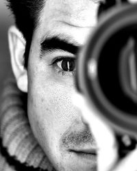 Close-up portrait of man photographing with camera