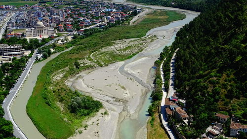 High angle view of road amidst trees in city