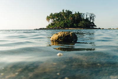 Surface level of sea against clear sky