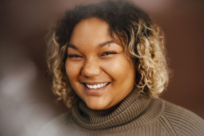 Portrait of happy young woman in studio