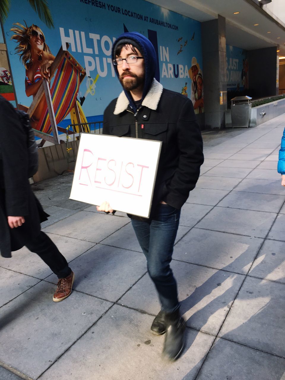 full length, holding, social issues, adults only, only men, people, business finance and industry, city, text, adult, banner - sign, men, young adult, one person, outdoors, one man only, day