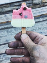 Close-up of hand holding ice cream cone