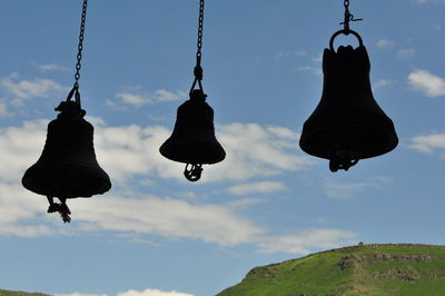 Low angle view of lanterns hanging against sky