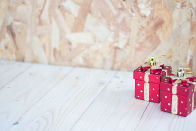 High angle view of red gift boxes on wooden table