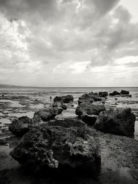 Rocks on beach against sky