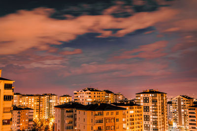High angle view of illuminated buildings against sky at sunset