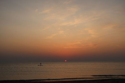 Scenic view of sea against orange sky