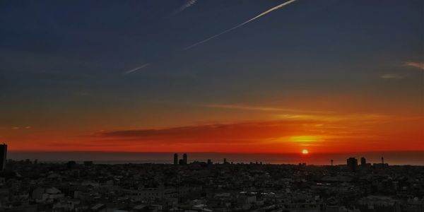 Silhouette of city during sunset