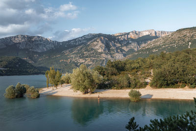 Scenic view of lake and mountains against sky