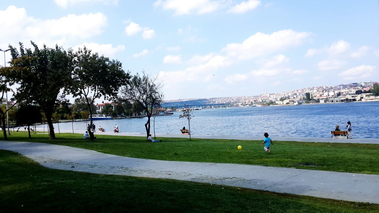 VIEW OF RIVER WITH CITY IN BACKGROUND